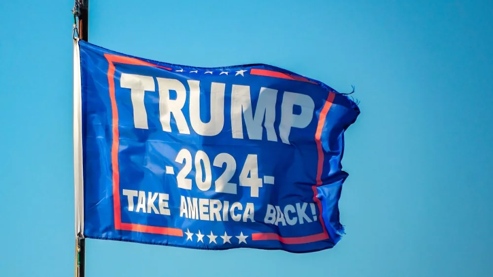 Trump 2024 flag flies at a pier on Coden Beach in Coden^ Alabama. Flag includes the slogan^ “Take America Back.”