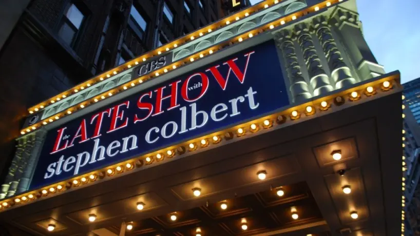 Manhattan NYC buildings in Times Square^ Broadway street avenue road^ signs for Stephen Colbert Late Show- Marquee / Theatre at Night
