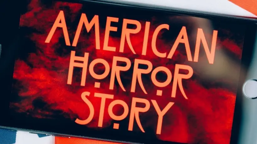 Screensaver with the 'American horror story' logo on a smartphone on toned background