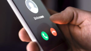 phone-call-from-unknown-number-late-at-night-scam-fraud-or-phishing-with-smartphone-concept-prank-caller-scammer-or-stranger-man-answering-to-incoming-call