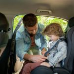 young-father-putting-seatbelt-on-his-little-son-sitting-on-backseat-of-the-car