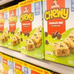 A view of several boxes of Chewy chocolate chip granola bars^ on display at a local grocery store.