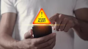 man-holding-smartphone-scam-alert-3