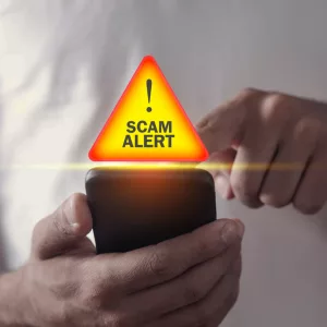 man-holding-smartphone-scam-alert-3