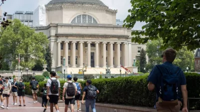 Students in the Columbia University campus on the Upper West Side of Manhattan. Steps of the Low Memorial Library in the background. New York^ NY^ USA - July 8^ 2022
