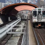 CTA Chicago Transit Authority elevated train tracks with green line train going through the tunnel above the Illinois Institute of Technology McCormick Tribune Campus Cente. Chicago^ IL April 20^ 2020