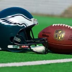 Philadelphia eagles equipment ^ ball and helmet on the green playing field ^ product shot