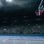 empty basketball court; shot of hoop and crowd in background