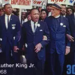 Martin Luther King during a protest march on postage stamp Milan^ Italy – January 7^ 2024