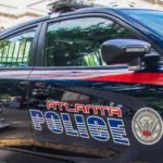 Atlanta police car and officer on cellphone Atlanta^ Ga USA - 06 07 20