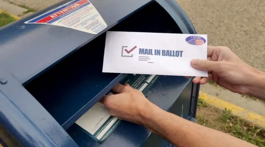 A man puts an absentee mail-in ballot in the mailbox. Circa August^ 2020