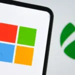 Microsoft logo on a smartphone screen and Xbox logo in the background. Indonesia - June 12^ 2025