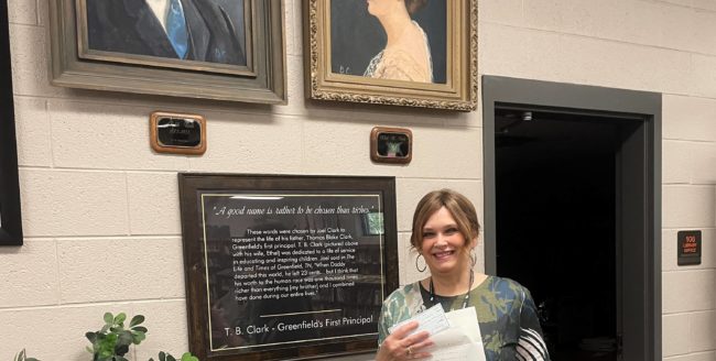 judy-martin-with-portraits-and-donation-check-and-books