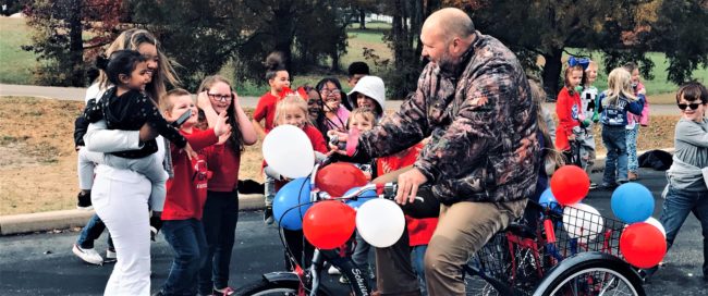 rhea-chris-on-bike
