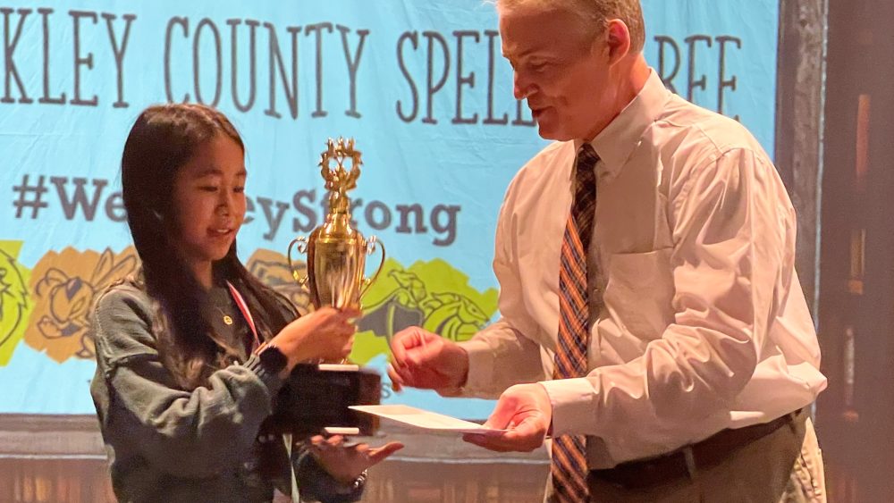wk-spelling-bee-winner-alina-vo-receiving-trophy