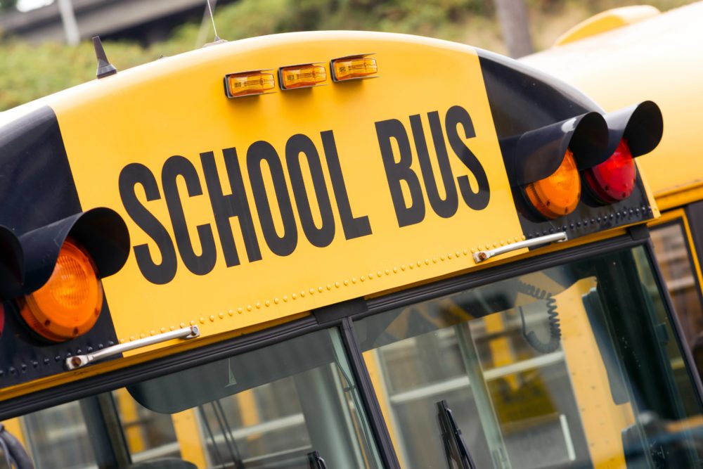 schoolbuschildreneducationaltransportsittingintheparkinglot