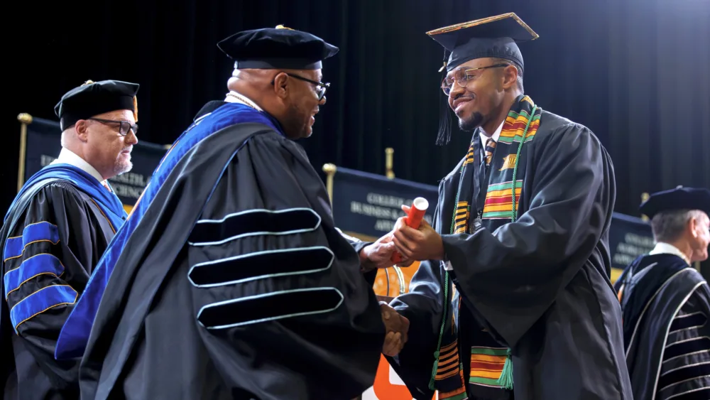 utm-shuan-harris-with-diploma