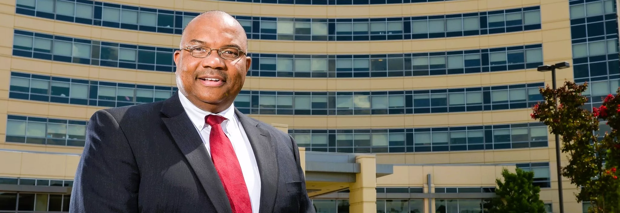chief-operating-officer-james-ross-in-front-of-entrance-to-jmcgh