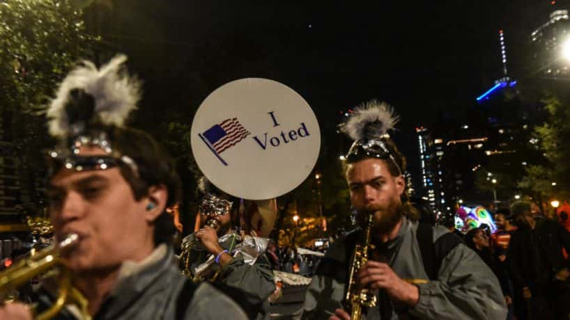 I Voted sticker over picture of a jazz band marching down the street