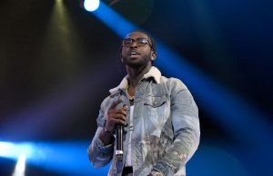 Pop Smoke on stage wearing a blue denim jacket