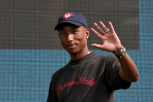 Pharrell Williams, US-American singer, enters the stage during festivities of the sporting goods manufacturer adidas. Shortly before its 70th anniversary, Europe's largest sports group celebrated the opening of a new main building at its headquarters in Herzogenaurach. 2100 of the 57 0000 Adidas employees worldwide work in the headquarters. Photo: Daniel Karmann/dpa