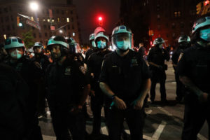 Police officers wearing shields of armor during the protest