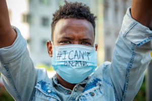 A protest with signs and masks reading I Cant Breath, following George Floyd's death in front of the consulate of United States of America during the Phase 2 of Coronavirus National Lockdown on May 28, 2020 in Milan, Italy. George Floyd died in police custody in Minneapolis, USA on Monday.
