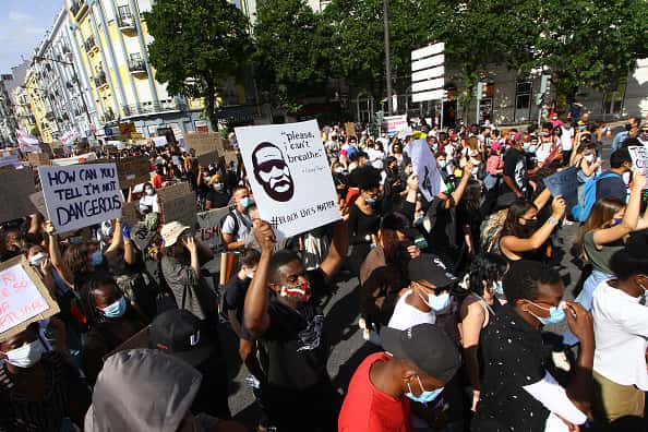 Protesters hold up posters during a march against racism, police violence, and in favor of respect for life on June 06, 2020 in Lisbon, Portugal.