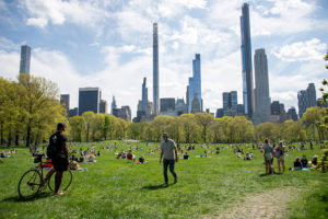 People wearing masks observe social distancing in Central Park as temperatures rise amid the coronavirus pandemic on May 3, 2020 in New York City. COVID-19 has spread to most countries around the world, claiming over 248,000 lives with over 3.4 million cases.