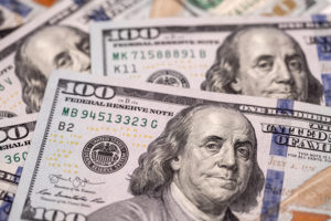 U.S. one-hundred dollar banknotes are arranged for a photograph in Hong Kong, China, on Thursday, April 23, 2020. The Hong Kong Monetary Authority intervened for a third straight day this week to defend its currency peg as the local dollar touched the strong end of its trading band.