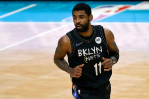 CHARLOTTE, NORTH CAROLINA - DECEMBER 27: Kyrie Irving #11 of the Brooklyn Nets runs the court during the fourth quarter of their game against the Charlotte Hornets at Spectrum Center on December 27, 2020 in Charlotte, North Carolina. NOTE TO USER: User expressly acknowledges and agrees that, by downloading and or using this photograph, User is consenting to the terms and conditions of the Getty Images License Agreement.