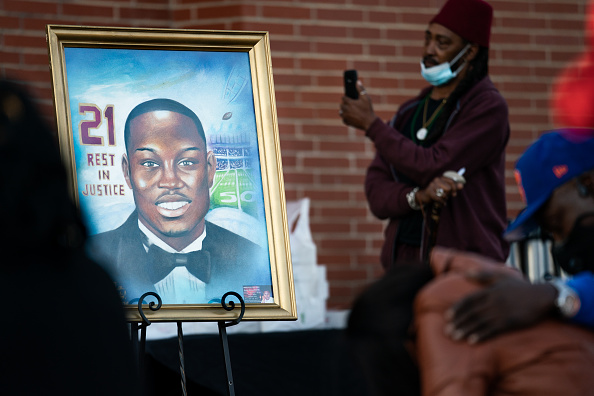 A painting of Ahmaud Arbery is displayed during a vigil at New Springfield Baptist Church on February 23, 2021 in Waynesboro, Georgia. Arbery, a Black man, was shot and killed while jogging near Brunswick, Georgia a year ago today after being chased by two white men.