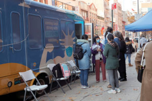 Principal Alice Hom (purple jacket) stands outside Yung Wing School P.S. 124 and a vax van where for the second time this month, pop-up sites have been stationed to offer students age 5-11 the covid vaccine on November 18, 2021 in New York City. These school pop-up sites will be back over a ten day period, starting on Nov. 30 according to New York City Mayor Bill de Blasio.
