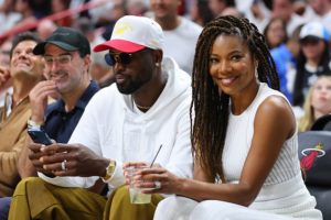 Former Miami Heat player Dwyane Wade and his wife, Gabrielle Union, look on courtside during the second half in Game Two of the Eastern Conference Semifinals between the Miami Heat and the Philadelphia 76ers at FTX Arena on May 04, 2022 in Miami, Florida. NOTE TO USER: User expressly acknowledges and agrees that, by downloading and or using this photograph, User is consenting to the terms and conditions of the Getty Images License Agreement.