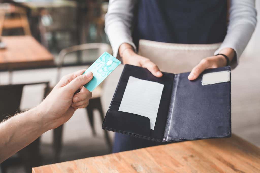 waitress with check and card