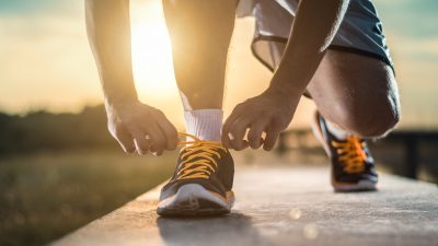 Man tying jogging shoes