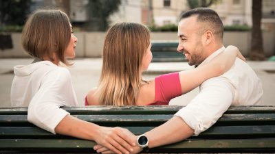mage of the love triangle between smiling cheerful people outdoor