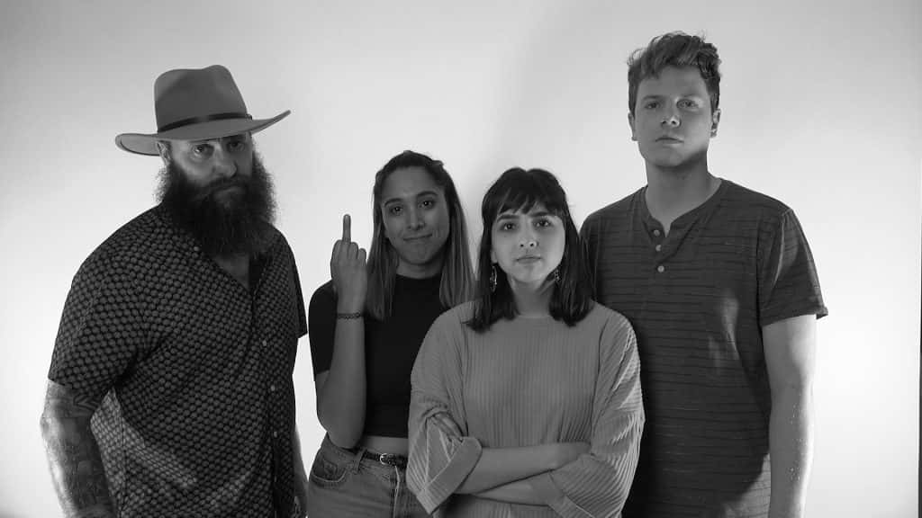 Four People flipping off a camera