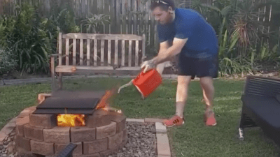 Man Pours Gas on a Fire