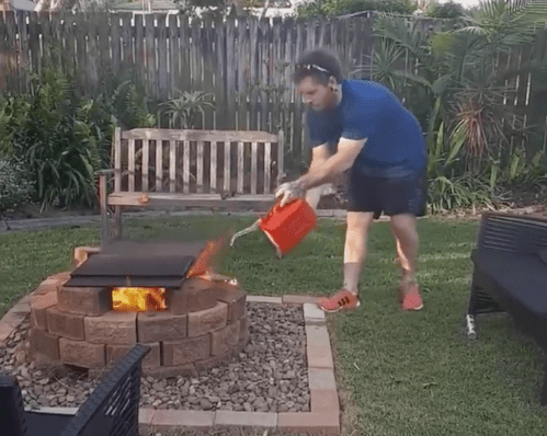 Man Pours Gas on a Fire