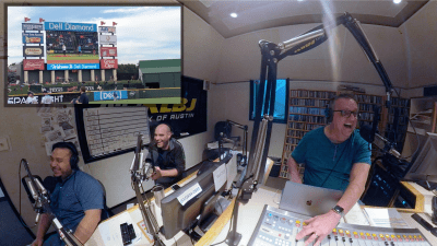 Guys in studio watching a video