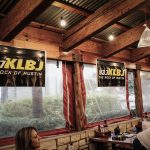 Dudley and Bob with Matt Breaking & Entering 2019: KLBJ signage at Rudy