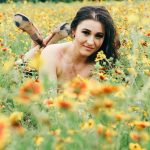Miss KLBJ Rock Girl Dominique: KLBJ Rock Girl Dominique laying in a field of wild flowers
