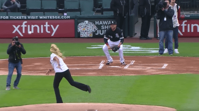 Woman throwing out a first pitch