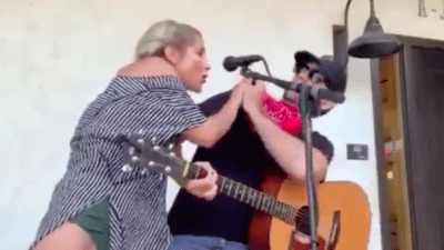 woman coughing on guitar player