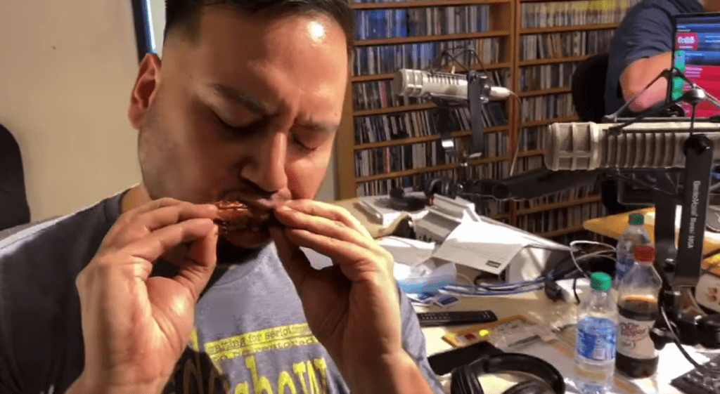 man eating a chicken wing