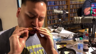 man eating a chicken wing