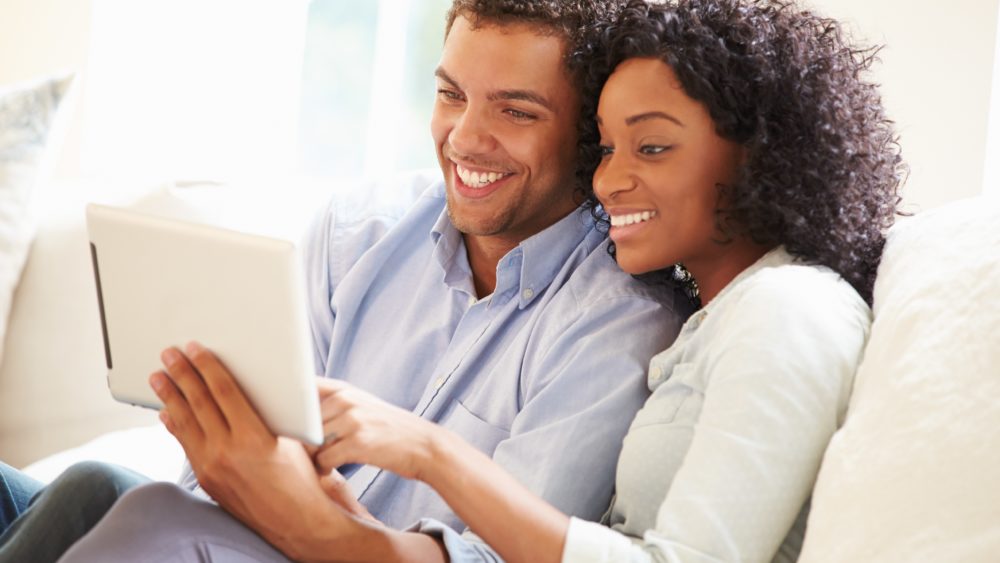man and woman looking at computer