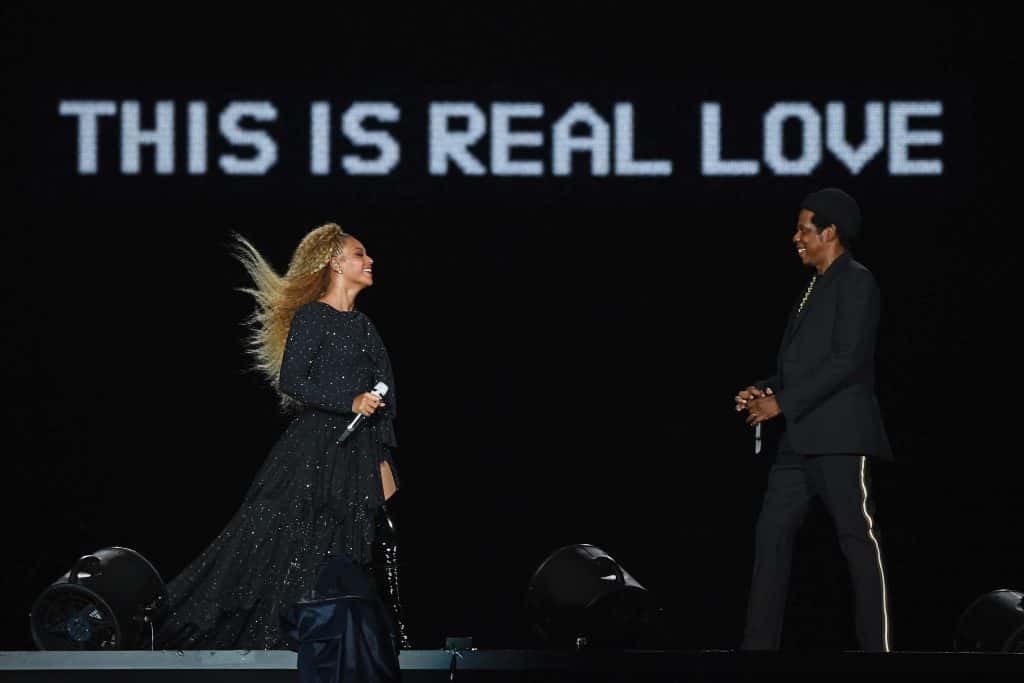 Beyonce and Jay Z On Stage With A Sign That Reads "This is Real Love"