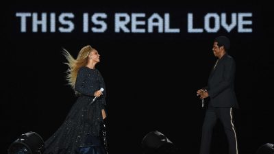 Beyonce and Jay Z On Stage With A Sign That Reads "This is Real Love"
